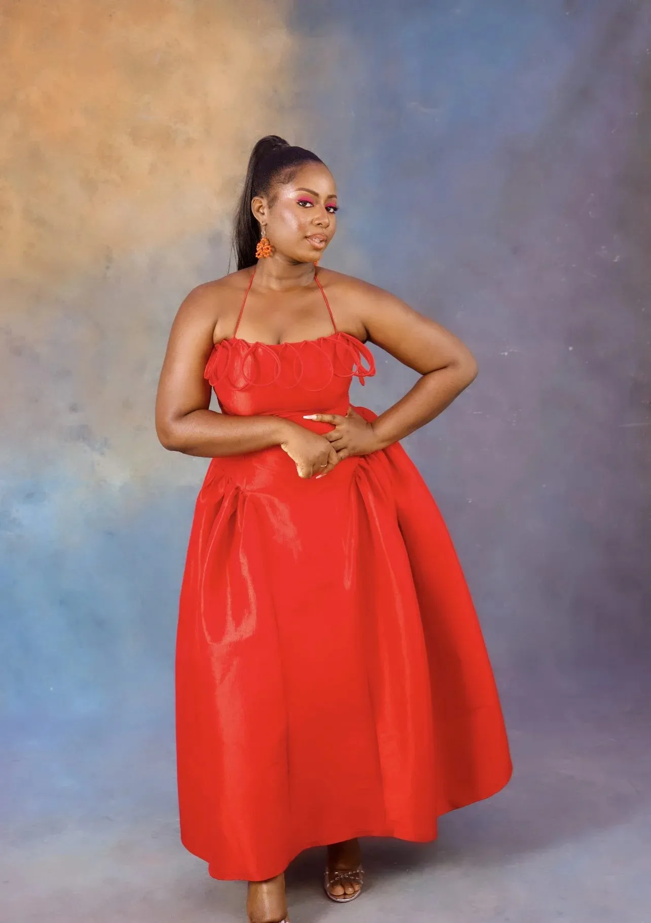 Desiree Iyama Meraki Midi Dress with Features a fitted bodice, elastic halterneck, exaggerated ovals at chest, back invisible zip